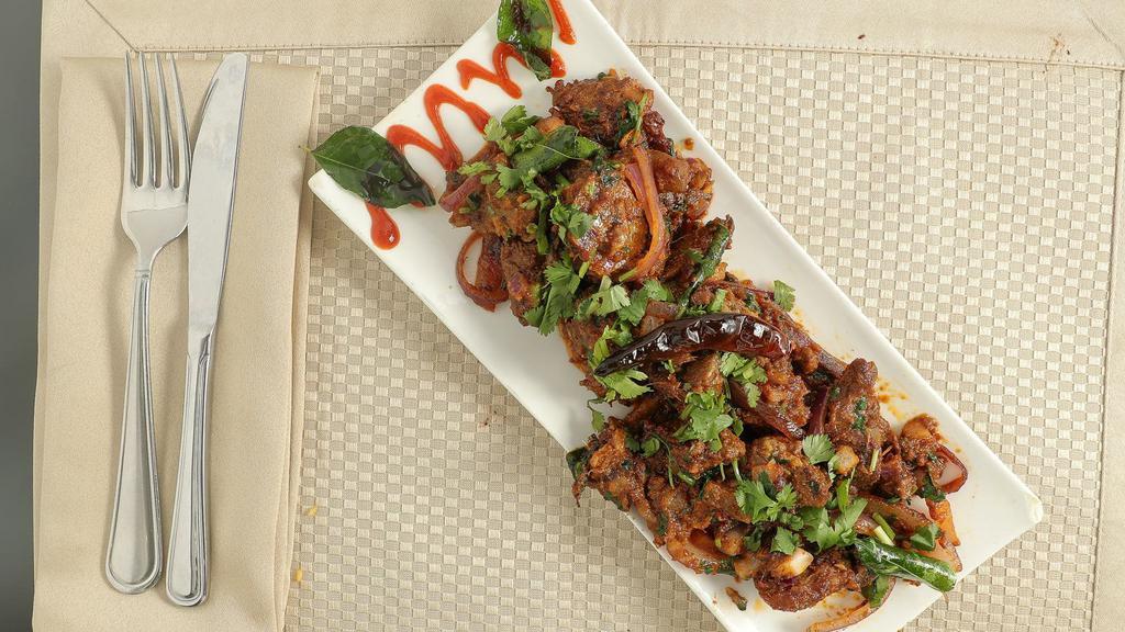Goat Sukha · Spicy. Goat marinated and sautéed in Indian spice spices.
