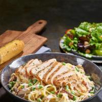 Chicken Carbonara · Grilled chicken served atop fettuccine tossed with alfredo sauce, bacon, peas, roasted baby ...