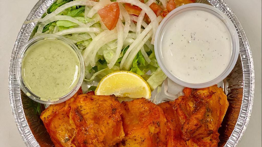 Fish Tikka · Salmon marinated and grilled to perfection in a tandoor oven.