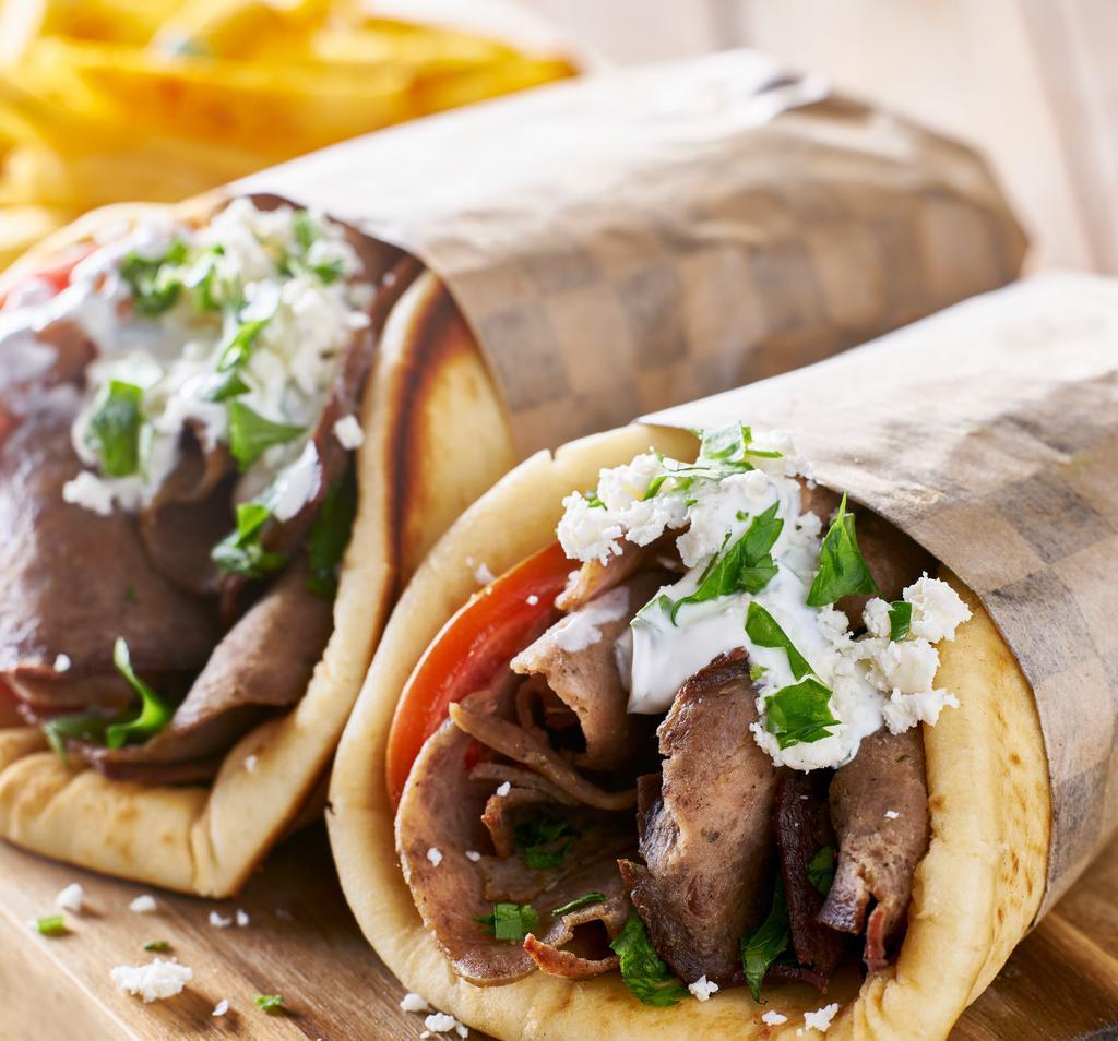 Gyro Sandwich · Beef and Lamb Gyro with Seasonings and Grilled to Perfection. Filled with Chopped Salad and Drizzled with
the Famous White Sauce
