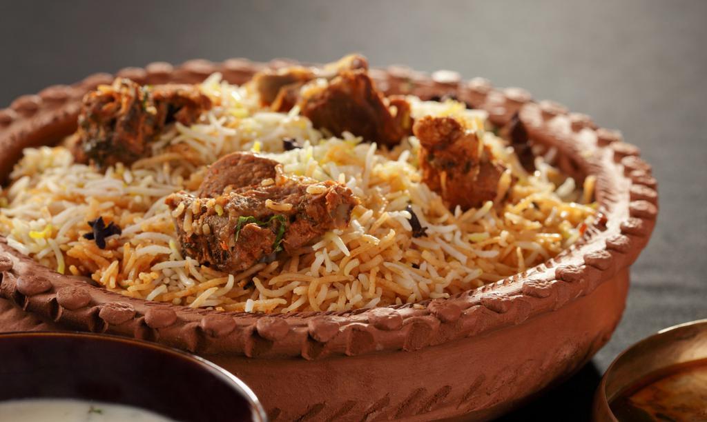 Lamb Biryani · A World-Renowned Fragrant Rice Casserole, Biryani takes time and practice to make but is worth every bit of
the effort. Basmati flavoured with Exotic Spices, such as Saffron, is layered with Lamb, and a Traditional Sauce
Blend. The dish is then sealed is cooked over a low flame. Enjoy with a Side of Cucumber Yogurt Raitha.