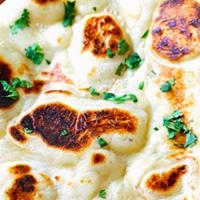 Naan Bread · India's famous white bread baked in clay oven pot (tandoor).