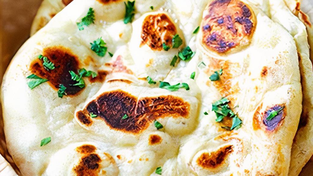 Naan Bread · India's famous white bread baked in clay oven pot (tandoor).