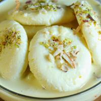 Rasmalai · Cheese dumpling in cardamom and pistachio flavored cream.