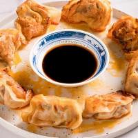Fried Pork And Chives Dumplings · Fried pork and chives dumplings with chili oil on top