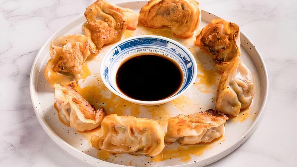 Fried Pork And Chives Dumplings · Fried pork and chives dumplings with chili oil on top