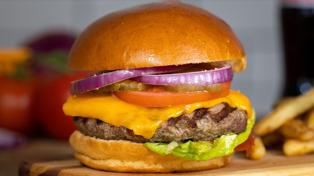 The Cheeser Burger · American Beef Patty topped with melted cheese, cooked medium served on a griddled bun, with lettuce, tomato, onion, and pickles.