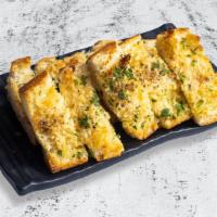 Cheesy Garlic Bread · Fresh bread, garlic butter schmear, mozzarella cheese, toasted until golden brown.