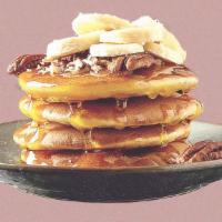 Banana Nut Pannies · 3 banana pancakes served with maple syrup, banana slices, toasted pecans, butter, and dusted...