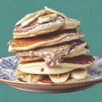 Peanut Butter Banana Pannies · 3 banana pancakes served with maple syrup, banana slices, peanut butter, butter, and dusted ...