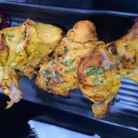 Tandoori Chicken · Tender pieces of chicken on the bone marinated with spices and a ginger garlic paste.