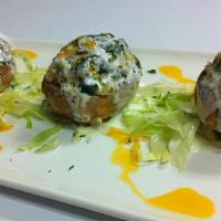 Stuffed Jumbo Mushrooms · Stuffed with spinach and blue cheese blended with a savory garlic beurre blanc.