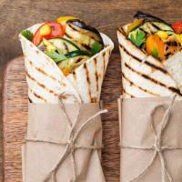 Veggie Wrap · Veggie filled wrap featuring sliced cucumber, arugula, delectable cheese, tomatoes, and red ...