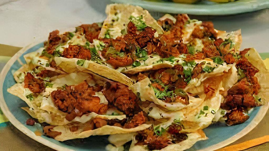 Chorizo Nachos · Chorizo with sautéed onion and peppers and topped with melted cheese loaded onto crispy tortilla chips.