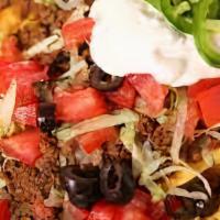 Sausage Nachos · Sausage with sautéed onion and peppers and topped with melted cheese loaded onto crispy tort...