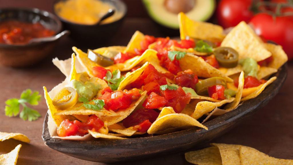 Vegetarian Nachos (No Meat) · Flavorful beef with sautéed onion and peppers and topped with melted cheese loaded onto crispy tortilla chips.