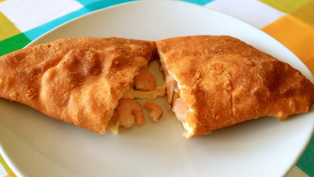 Shrimp Empanada · Hearty shrimp filled in a golden pastry shell.