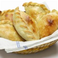 Chicken Empanada · Savory chicken filled in a golden pastry shell.