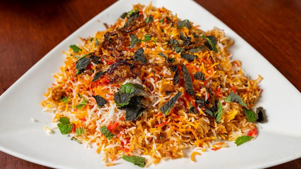 Chicken Biryani · With bones. Succulent pieces of chicken and long grain rice cooked in a sealed pot with a mild blend of spices.