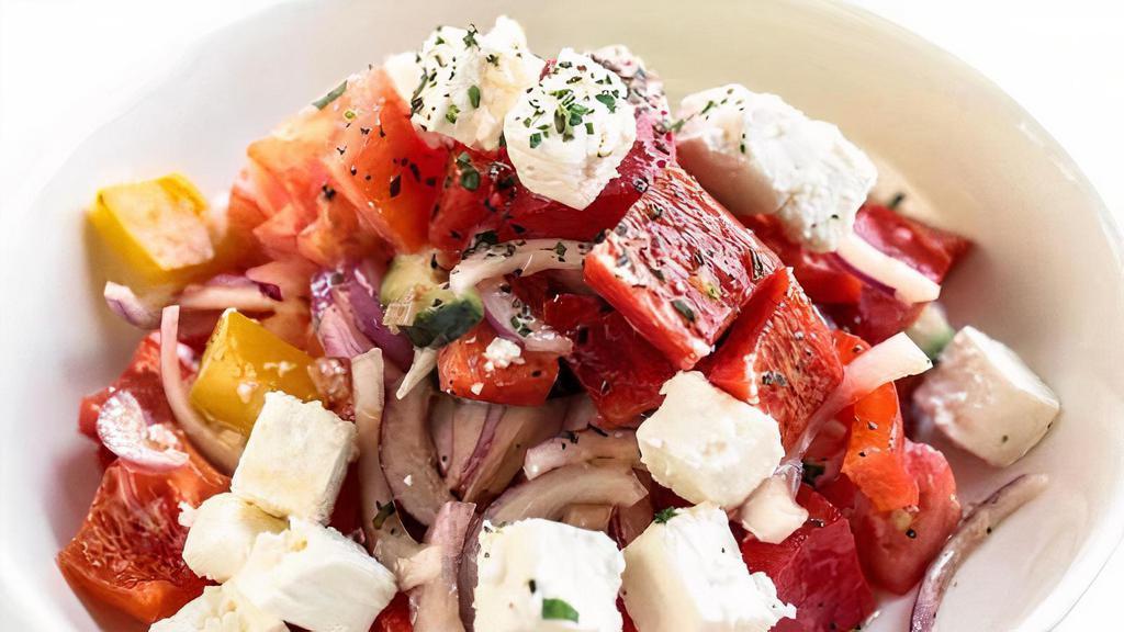 Classic Greek Salad · Heirloom tomatoes, vine ripe tomatoes, cucumbers, onions, olives, bell peppers, feta, white balsamic vinaigrette.