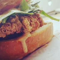 Crispy Chicken Sandwich · Organic boneless chicken breast, served on a pretzel bun with organic spinach, tomatoes and ...