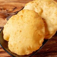 Poori (2 Pieces) · Puffed bread. Served with dal, cabbage, onion chutney, and coriander sauce.