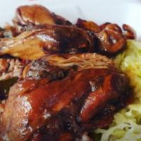 Brown Stew Chicken · Rice, cabbage, and plantain.