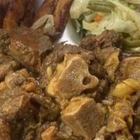 Curry Goat · Rice, cabbage, and plantain.