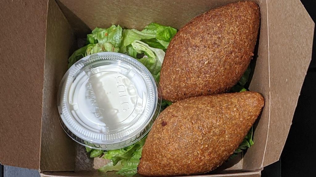 Kibbeh · bulgur croquettes fried and filled with ground beef with side of yogurt-tahini sauce (qty 2).