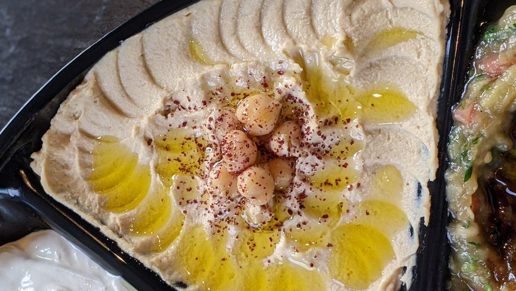 Hummus · creamy chickpea dip with tahini & olive oil. vegetarian.  includes pita.