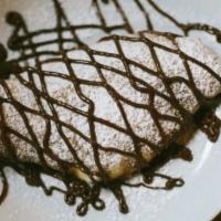 Dessert Calzone · Calzone stuffed with honey ricotta, drizzled with Nutella, powdered sugar, and sea salt.