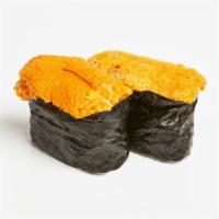 Uni Nigiri · Two pieces of uni over pressed sushi rice.