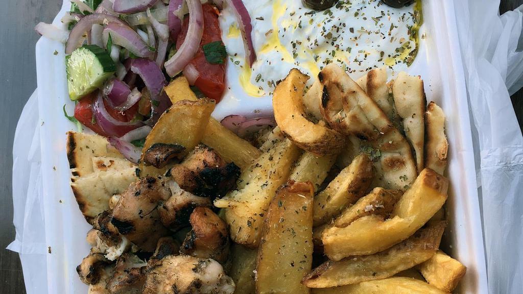 Chicken Souvlaki Platter · Two sticks of our hand skewered chicken souvlaki over our Hand Cut fries or yellow rice.
comes with a side salad and your choice of bread, sauce, and toppings.