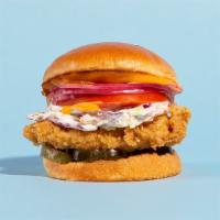 The Fried Chicken Sandwich · Buttermilk fried and served on a brioche bun with slaw, tomatoes, pickles, onions, and a chi...