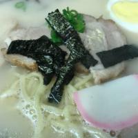 Tonkatsu Ramen · Pork bone broth ramen noodle soup. With sliced pork, vegetables, egg, fish cake.