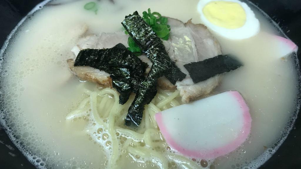 Tonkatsu Ramen · Pork bone broth ramen noodle soup. With sliced pork, vegetables, egg, fish cake.