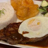 Ny Strip Steak In Roti Sauce · Served with roti sauce over rice, fried egg, Spanish potatoes.