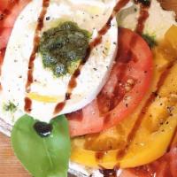 Tomato Burrata · Herbed ricotta, pesto, tomatoes, burrata, basil, olive oil, balsamic glaze on rustico toast....