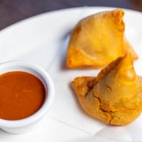 Samosa · Crispy pastry stuffed with spiced potatoes, and peas.