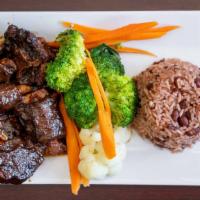 Oxtails · Oxtails braised & slowly stewed w/ lima beans served rice & peas or white rice and steamed v...