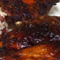 Jerk Chicken · Grilled jerk chicken topped jerk spices served w/ rice & peas or white rice and steamed vegg...