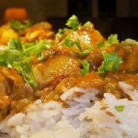 Curry Chicken · Chicken cooked w/curry & traditional island spices  choice of rice & peas or white rice & st...