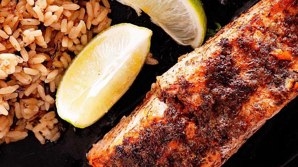 Jerk Salmon · Grilled Salmon topped w/jerk spices w/ rice & peas or white rice and steamed veggies