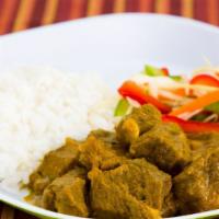 Curry Goat · Goat meat slowly cooked in curry & traditional island spices served w/ rice & peas or white ...