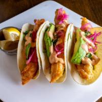 Fish Tacos · 3 crispy salmon fish tacos filled with guacamole, salsa, pickled onions and vinegar coleslaw.