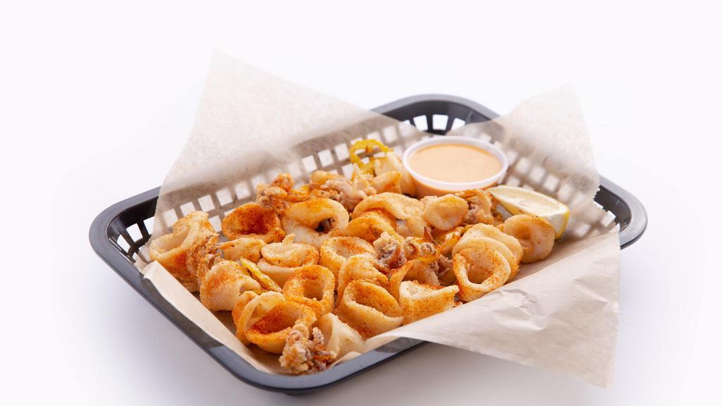 Spicy Calamari · Deep fried calamari with a mild spice, tossed with banana peppers and a spicy aioli dipping sauce.