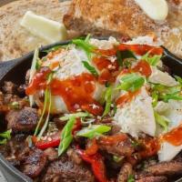 Bulgogi Beef Breakfast Skillet · Bulgogi Beef served with House-Made Hash Browns topped with poached eggs, Green Onions, Sesa...