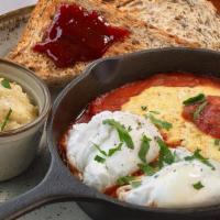 Shakshuka Grits · 2 Poached eggs in a slightly spiced & rich tomato sauce served with a side of creamy Delta G...