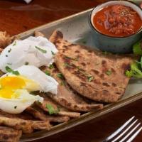 Poached Egg Aloo Paratha · 2 Poached eggs over Aloo Paratha served with a side of spicy Tomato Chutney