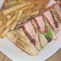The Buzz Club Sandwich  · Slightly toasted bread with turkey, bacon, lettuce, and tomatoes. Served with fries.
